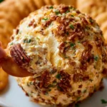 Pineapple cheese ball served with crackers on a festive platter