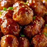Slow Cooker Teriyaki Meatballs in a bowl with sauce and garnish